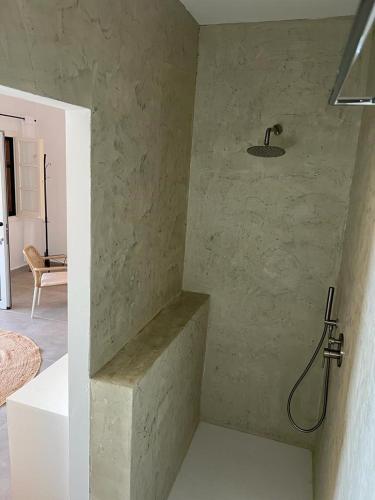 a shower in the corner of a room at Elysium Apartments Corfu in Paleokastritsa