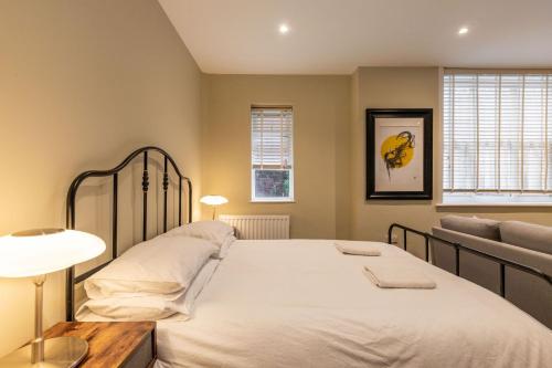 a bedroom with a large bed and a couch at Cromer Town Apartment 1 - Norfolk Holiday Properties in Cromer