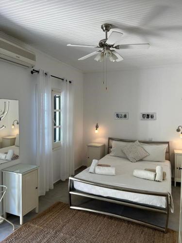 a bedroom with a bed and a ceiling fan at Elysium Apartments Corfu in Paleokastritsa