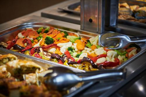 a tray of food with vegetables on a buffet at Hotel Adria in Dubrovnik