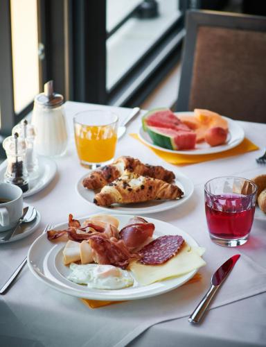 a table with two plates of breakfast food on it at Hotel Adria in Dubrovnik