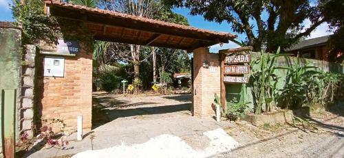 an entrance to a brick building with a sign at Casa Dos Artistas in Penedo