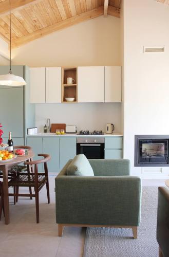 a living room with a couch and a table at Jardin de la Ferme in Franschhoek