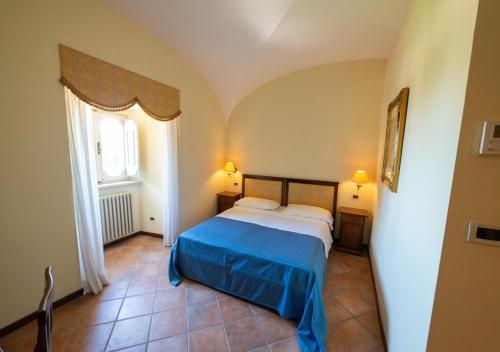 a bedroom with a bed in a room with a window at Villa Tuscolana in Frascati