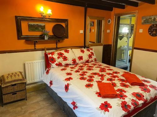 a bedroom with a bed with red towels on it at Yarm cottages Haystacks in Kirk Leavington