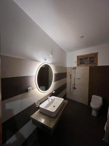 a bathroom with a sink and a toilet at ISLE OF HIGHLAND TOURS Guest House in Gilgit