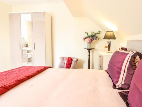 a bedroom with a large bed and a window at Maesbury Manor in Oswestry