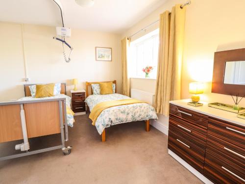 a bedroom with a bed and a sink and a window at Maesbury Manor in Oswestry