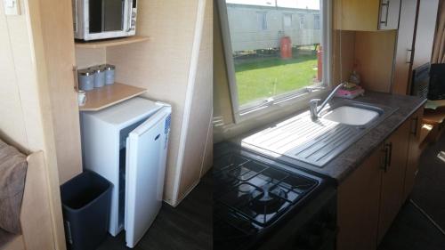 a small kitchen with a sink and a refrigerator at Adorable 2 bedroom holiday home in Clacton-on-Sea in Clacton-on-Sea