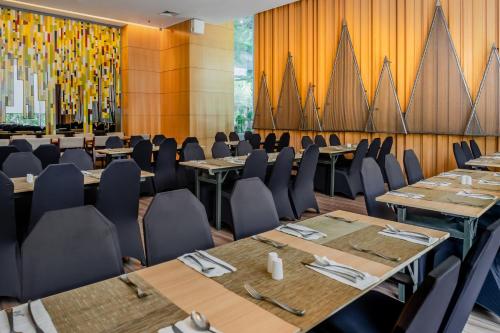 a conference room with tables and chairs and a wall at DoubleTree by Hilton Jakarta Kemayoran in Jakarta