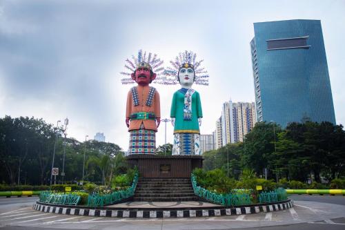 a large statue of two people in a city at DoubleTree by Hilton Jakarta Kemayoran in Jakarta