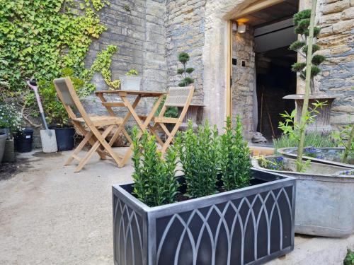 a table and two chairs and a table and chairs at The Undercoft luxury private studio at The Old Church House central Frome in Frome