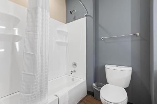 a white bathroom with a toilet and a shower at Extended Stay America Premier Suites - Augusta in Augusta