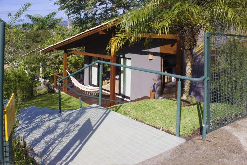 a gate leading to a house with a ramp at Studios Altos da Igrejinha in Florianópolis