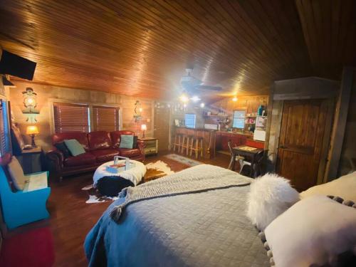 a bedroom with a bed and a couch in a room at 8th St. Cowboy Haus I Biker Friendly I River in Bandera
