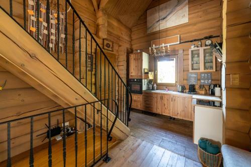 a staircase in a room with wooden walls and wooden floors at Vendégház a hegyen in Budapest