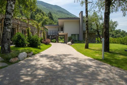 a driveway leading to a house with trees at Gazzi Apartments 'Panoramic & Relaxing' in Arco