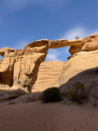 a rock formation in the desert with a bridge at Wadi Rum Magic Camp in Wadi Rum