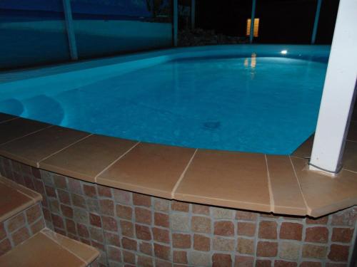 a large swimming pool with a tiled floor and a brick wall at Villa Celeste B&B in Pontecagnano