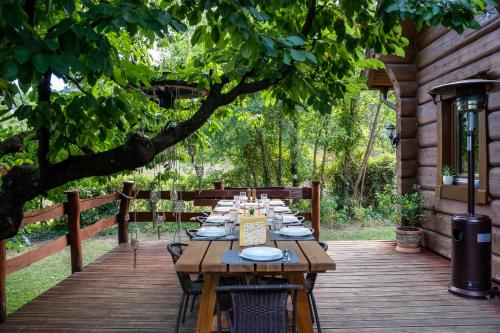 a wooden table sitting on a wooden deck at Vendégház a hegyen in Budapest
