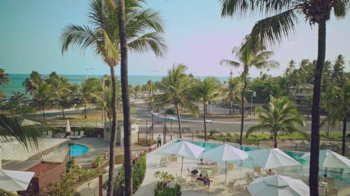 an aerial view of a resort with a pool and palm trees at CASA Di VINA Boutique Hotel in Salvador