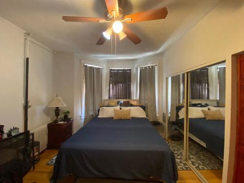 a bedroom with a bed and a ceiling fan at Room with Jacuzzi, Massage Seat, and Parking Spac, THE BEST CHOICES!! in North Bergen