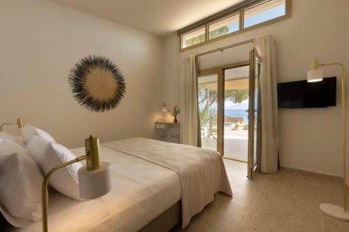 a bedroom with a bed and a view of the ocean at Villa Aura Loutraki in Loutraki