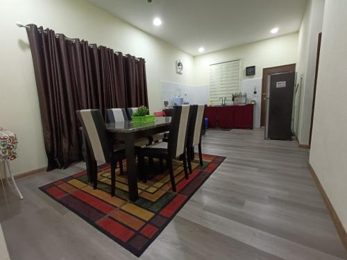 a dining room with a table and chairs at Fadli HOMESTAY in Kota Bharu