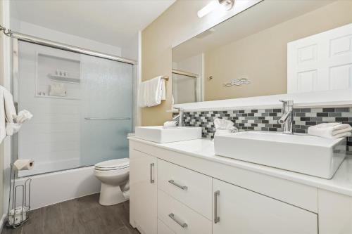 a bathroom with a sink and a toilet and a shower at Sapphire Shores - Sarasota Bungalow w/ Heated Pool and Backyard Oasis in Sarasota