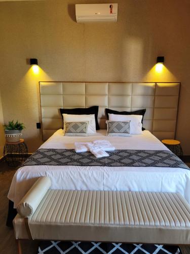 a bedroom with a large bed with two towels on it at Pousada Lago Azul in Delfinópolis