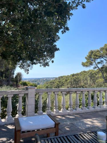 a bench in front of a white railing at La Farigoule in Aix-en-Provence