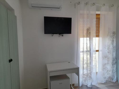 a living room with a television on a wall at Cuore Verde del Cilento in Laureana Cilento