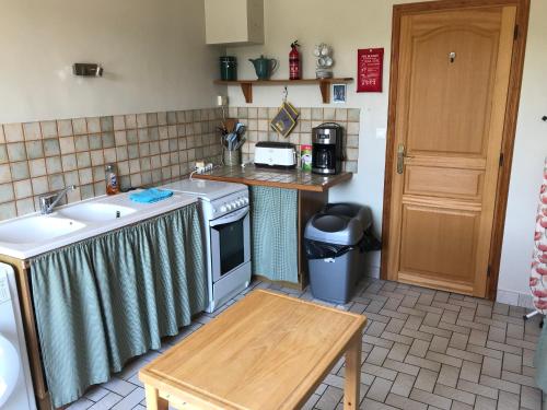 a kitchen with a sink and a stove at The Linden House in Saint-Yrieix-les-Bois