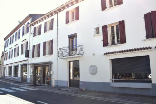 a white building on the side of a street at LE LYS in Lacrouzette