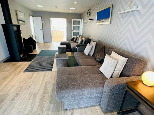 a living room with a couch and a table at Pass the Keys Fabulous Beach Front Holiday Location in Lydd