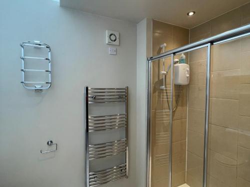a bathroom with a shower and a glass shower stall at Pass the Keys Beautiful 2BR Converted Mill - Idyllic Location in Dumfries