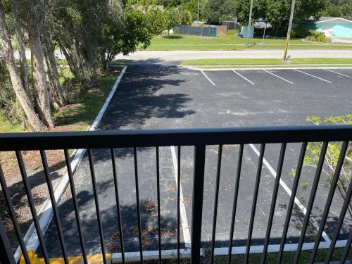 a view of a parking lot from a balcony at Remodeled, Huge Pool, Tiki Bar & Grill, Quiet Room in Sarasota