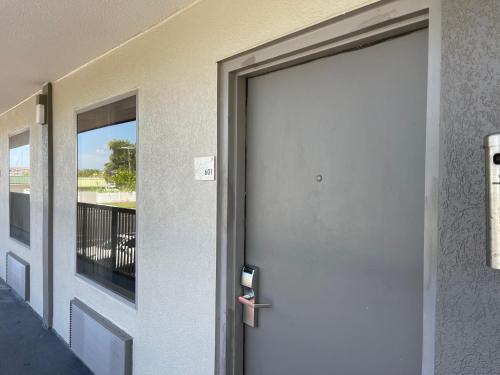 a door to a building with a balcony at Remodeled, Huge Pool, Tiki Bar & Grill, Quiet Room in Sarasota