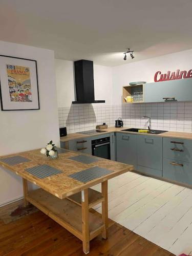 - une cuisine avec une table en bois dans une chambre dans l'établissement Maison de ville dans le centre historique de Cahors - Cosy townhouse in the historical center of Cahors, à Cahors