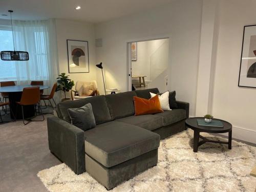 a living room with a couch and a table at Brand new 3-bedroom home in London in London