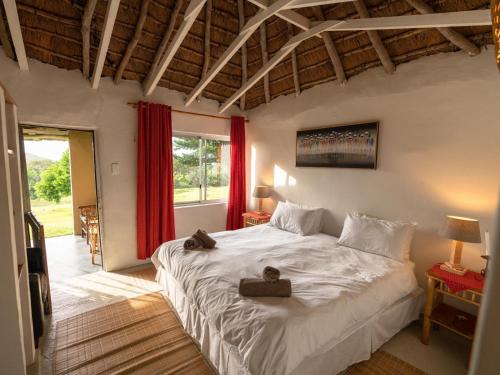 a bedroom with a large bed with two towels on it at THE HAVEN HOTEL in Mpume