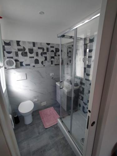 a bathroom with a glass shower and a toilet at Agriturismo Soleada in Ventimiglia