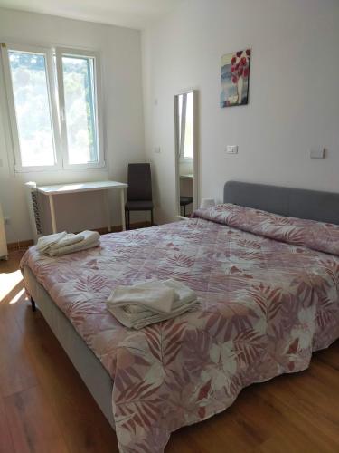 a bedroom with a bed with two towels on it at Agriturismo Soleada in Ventimiglia