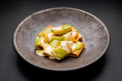 a plate of food on a table at Habitat Boutique Hotel in Catania