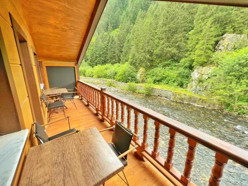 a balcony of a house with a view of a river at Raha Villa Bungalow in Uzungol