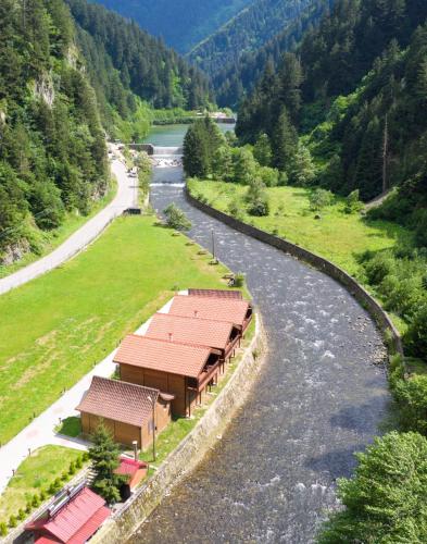 arial view of a river with a building next to a mountain at Raha Villa Bungalow in Uzungol