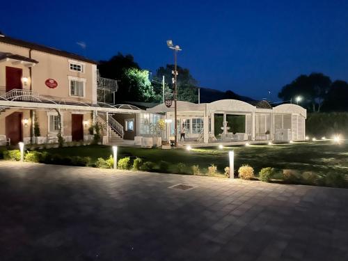 a large white building with lights in front of it at Ca' del Conte - Maison de Charme in Padula