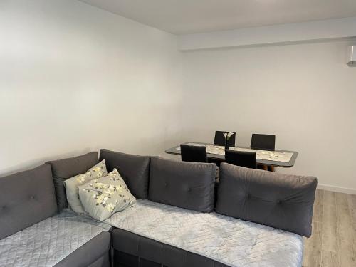 a living room with a couch and a table at Apartman Jure in Široki Brijeg