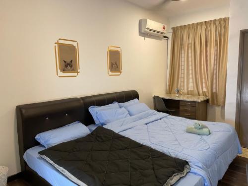 1 dormitorio con 1 cama grande con sábanas azules en Homestay Balik Pulau en Balik Pulau