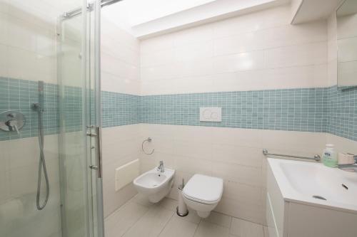 a bathroom with a toilet and a sink and a shower at Amalfi 90 - holiday house close the beach in Atrani